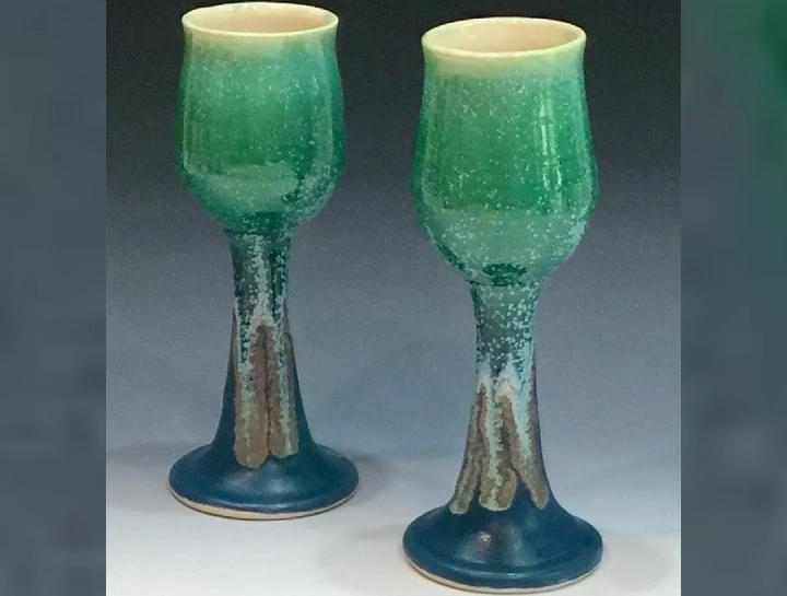 A pair of green and blue wine glasses.
