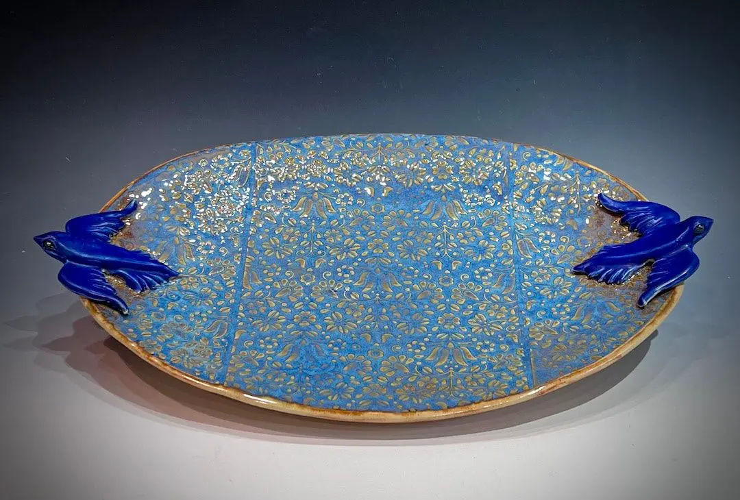 A blue plate with gold and blue designs on it.