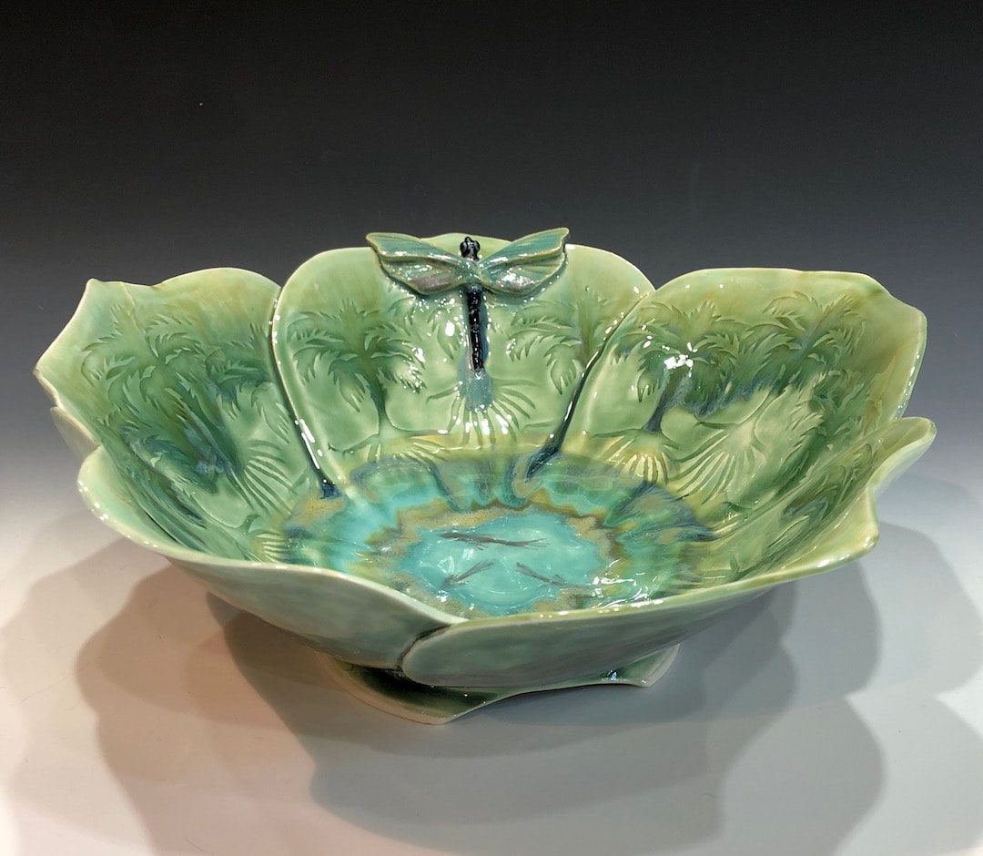 A green bowl with a dragonfly on the side.