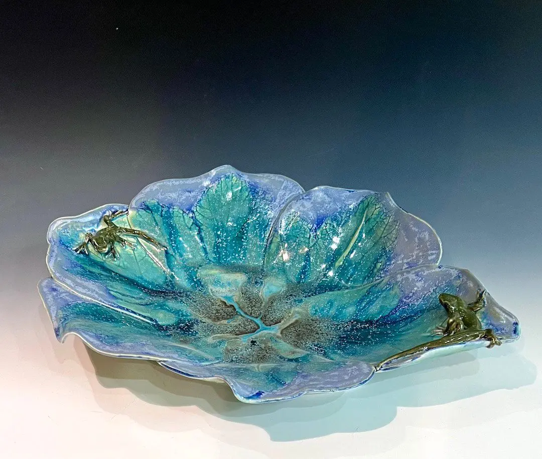 A blue bowl with a flower design on it.