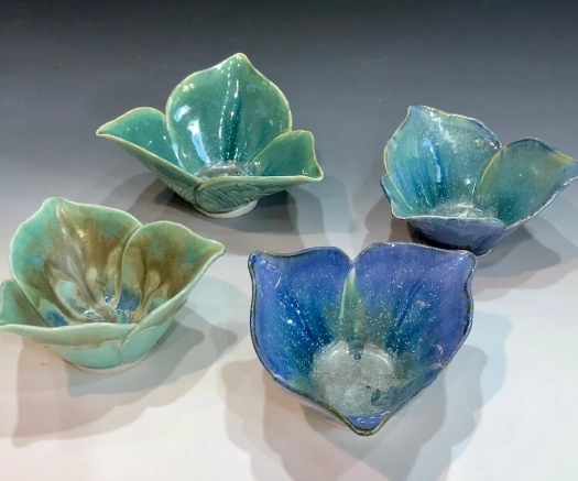 A group of five bowls that are made from clay.